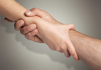 Two hands hold each other, need of help