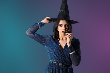 Young witch on dark color background