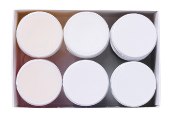 Round plastic jars in a paper box, top view