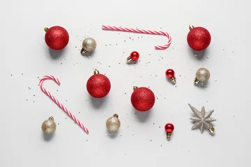 Foto op Plexiglas Composition with Christmas balls and tasty candies on light background © Pixel-Shot
