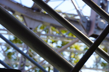 Metal steel construction background. Beams and handrail details. Focus in the front, blurred in the...