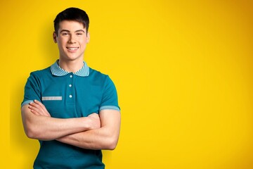 Young happy man standing over color background