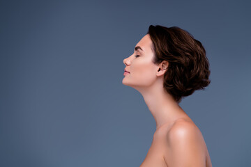 Photo of side view of pretty lovely lady enjoying procedure for soft silky skin over grey color background