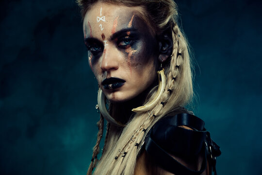 Close up photo of powerful viking queen princess with scar experienced fighter in north war over dark background