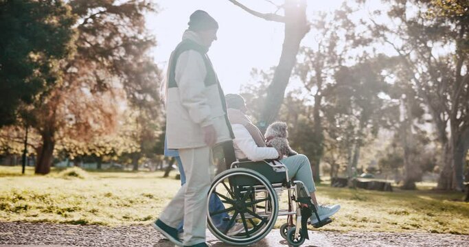 Nurse, senior woman and wheelchair in park with man, dog or walking in morning sunshine with conversation. Caregiver, couple and elderly person with disability and pet, animal or puppy in retirement