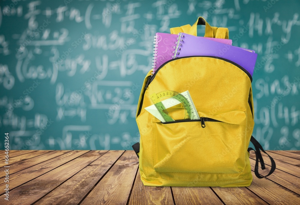 Canvas Prints school backpack with stationery on table near chalkboard