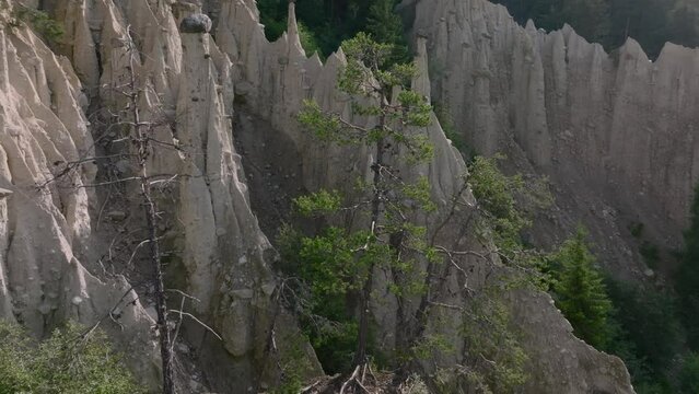Aerial Drone shot over the Earth pyramids of Platten in South Tyrol in Alps near to Bruneck or Brunico, Bolzano, Italia