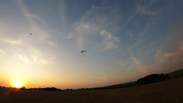 Parachutist Landing at Sunset: Soft Landing, Orange Sky with Silhouette