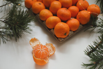 Christmas background with fir tree branches and tangerines. Merry Christmas and Happy New Year Greeting Card