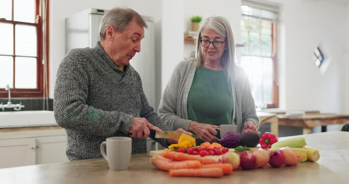 Old couple in kitchen, cooking together with conversation and help, support or planning recipe with vegetable. Healthy food, senior man and woman in home with discussion for meal prep, diet and lunch