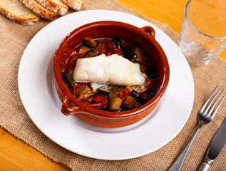 Hearty lunch, cooked xanfaina cod with seasonal vegetables in baking dish. Healthy food,...