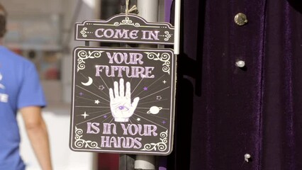 This video shows a palm reading sign that reads "your future is in your hands".