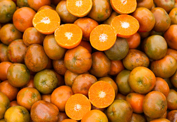 Photograph of a group of mandarins in a South American market. Fruit concept.