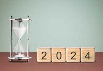 Flipping wooden block 2023 to 2024 concept with hourglass o