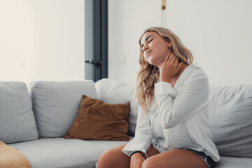 Close up tired woman massaging neck muscles after long sedentary work, exhausted girl feeling discomfort, unwell and unhealthy, suffering from strain or spasm, health problem concept.