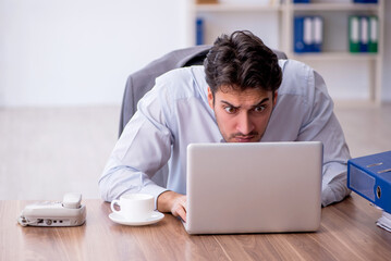 Young male employee working in the office