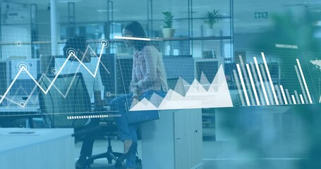 Animation of graphs, loading bars and map over diverse coworkers discussing on desk