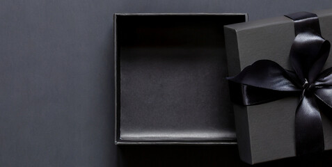 blank open black present box or top view of black gift box with black ribbons and bow isolat