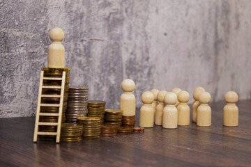 Three?pile?of?coins?and?a?small?wooden?ladder. concept