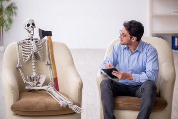 Young male psychologist meeting with skeleton