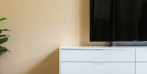 cabinet for tv on the cream color wall in living room minimal design 