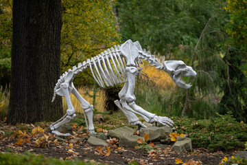 Prehistoric bear skeleton figurine outdoors.