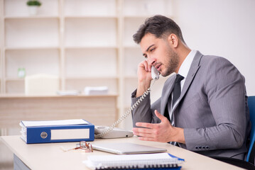 Young male employee working in the office