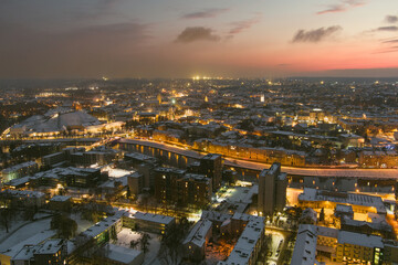 Fototapeta na wymiar Beautiful aerial evening view of illuminated business district in Vilnius. Winter sunset in capital of Lithuania.