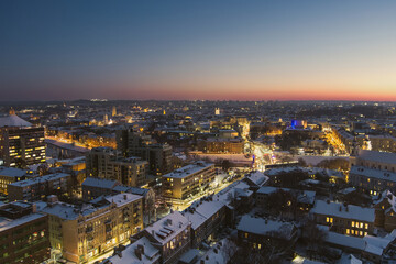 Beautiful aerial evening view of illuminated business district in Vilnius. Winter sunset in capital of Lithuania.