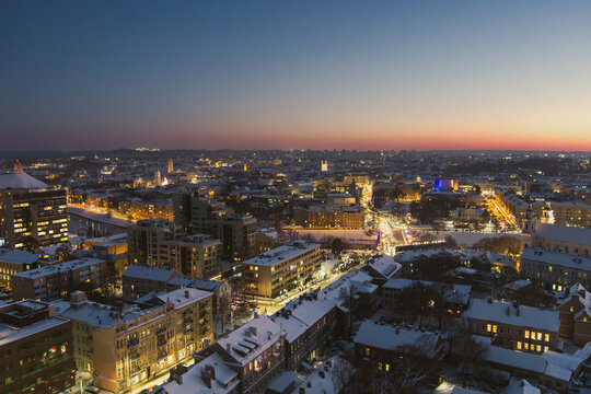 Fototapeta Beautiful aerial evening view of illuminated business district in Vilnius. Winter sunset in capital of Lithuania.