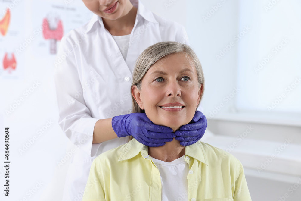 Wall mural Endocrinologist examining thyroid gland of patient at hospital, closeup