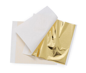 Edible gold leaf sheets on white background, top view