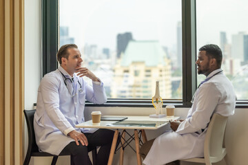 Shot of diverse doctors creating positive relationships, smiling, sharing ideas during breaks.