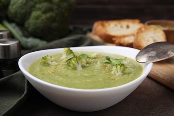 Delicious broccoli cream soup served on grey table, closeup