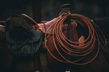 western saddle with lariat rope and saddle bags