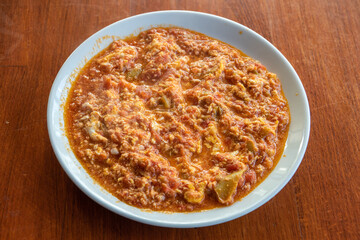Menemen, a popular traditional Turkish dish made of eggs, tomato, green peppers, and spices such as ground black and red pepper cooked in olive oil.