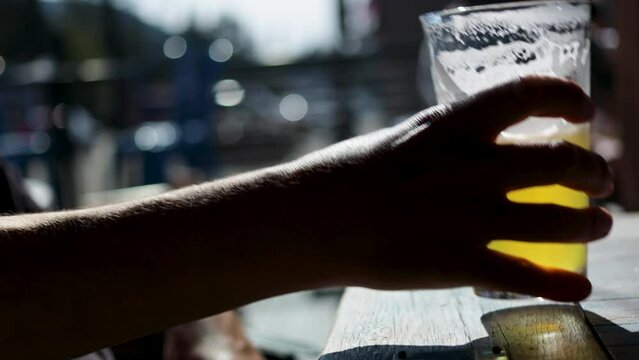 Golden Hour Sip Man's Hand Grabs a Hazy IPA on a Sunny Day