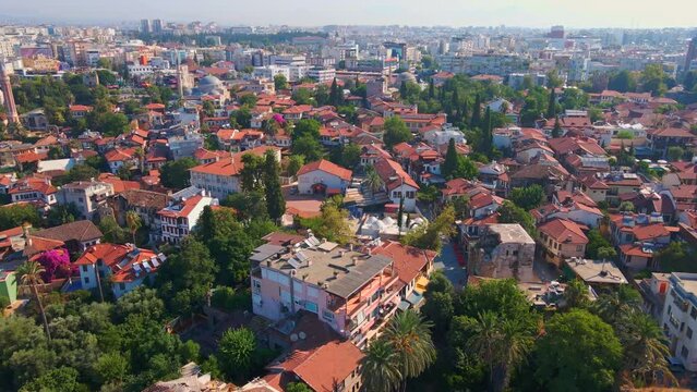 Experience the enchantment of Antalya's historic heart through this captivating aerial stock video. Winding narrow streets, bustling markets, and elegant mosques weave a vibrant tapestry of culture