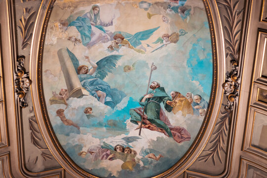 fresco paintings with many angels, gods, Jesus, etc. in the sky. in an ancient cathedral church of many colors. church ceiling and paintings under repair