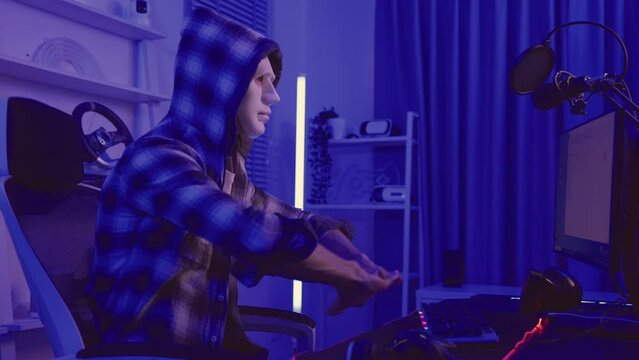 Short of computer hacker wearing white mask stealing data from a laptop.