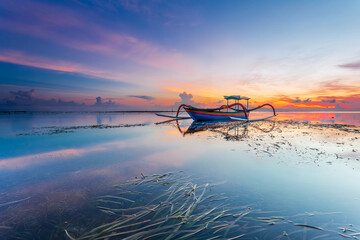 Morning sun in Bali, Indonesia. Traditional fishing boats at Sanur beach, Bali, Indonesia. - 664721750