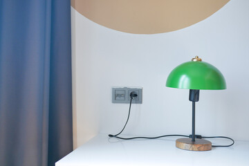 table lamp against orange color wall in bed room 