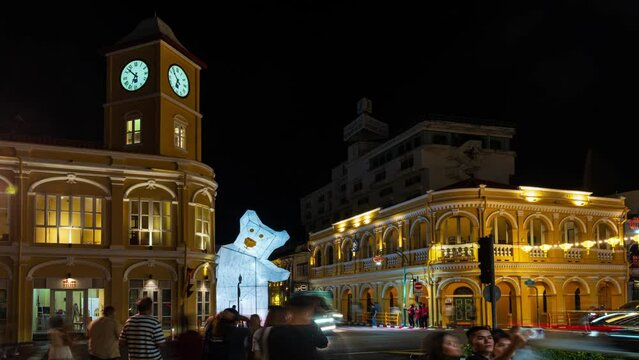 PHUKET ,THAILAND OCT 2023 : Time lapse video Day to Night old building sino-portuguese style at phuket oldtown with Busy traffic and colorful sunset background in travel and transportation concept