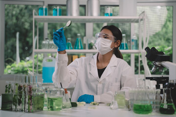 Fototapeta premium Asian researchers or scientists keeping and looking fresh cucumber samples in green lab for research product skin care cosmetic