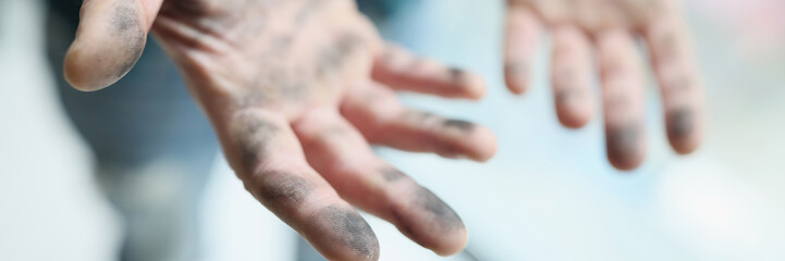 Foreman shows dirty palms after cleaning dusty premise