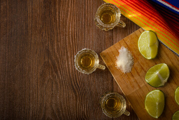 Tequila shots with salt and lime on a bar table. Shots of tequila and typical mexican elements.
