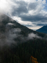 Canadian Mountain Landscape Covered in Clouds. Aerial Nature Background.