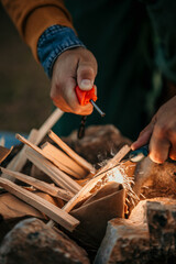 A man skillfully crafts a crackling fire.