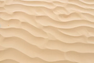 Fotobehang Closeup of sand pattern of a beach in the summer. © RABEYAAKTER