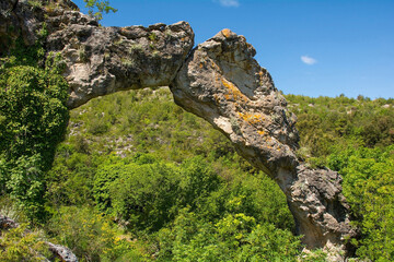 Kolac Rock Arch near Nerezisca on Brac Island, Croatia. A result of a mixture of steambank, wind, water and temperature erosion, and protected as a geomorphological monument of nature, it is made of l